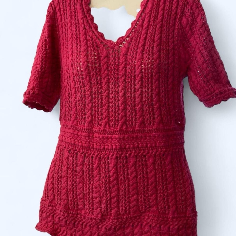 Pink crochet babydoll top with short sleeves and V-neckline. Chadwick M